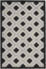 Close-up of Nourison Aloha Black White Modern Area Rug featuring a bold diamond pattern and textured weave.