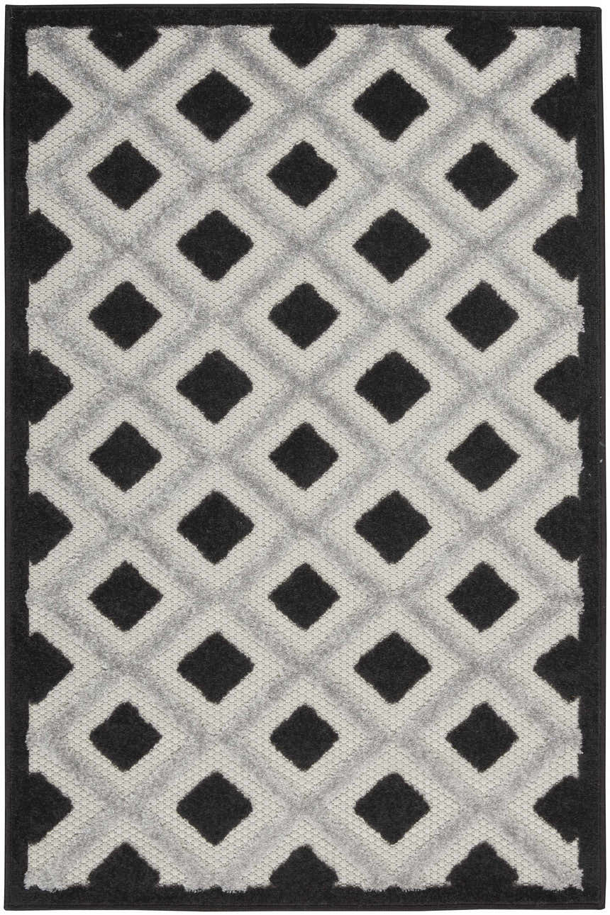 Close-up of Nourison Aloha Black White Modern Area Rug featuring a bold diamond pattern and textured weave.