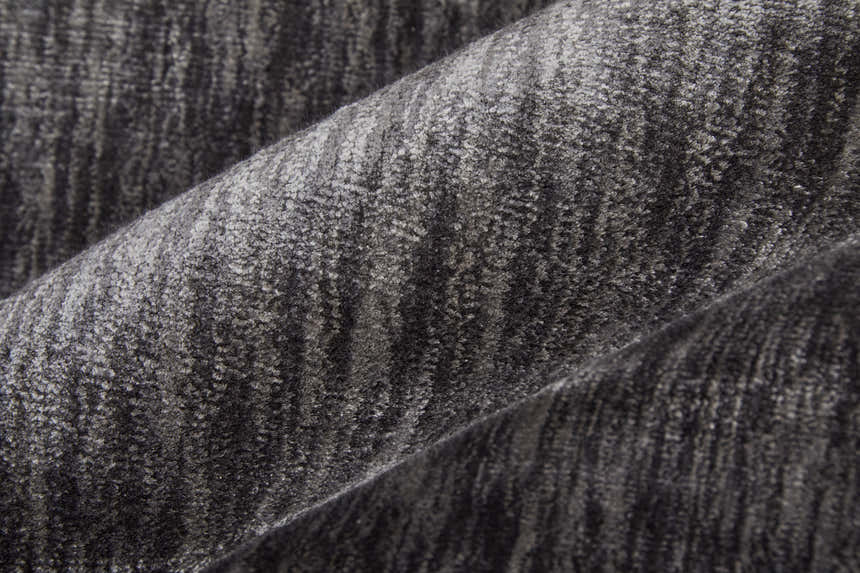 Close-up of the textured Feizy Marlowe rug in gray and taupe, showing the hand-woven chevron pattern. Texture