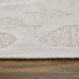 Close-up of Feizy Saphir Mira rug showing pink geometric diamonds on a white background with a soft, textured pile. Pile