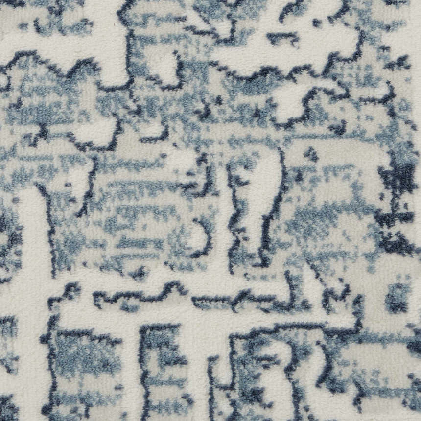 Close-up of the Nourison Urban Chic Ivory rug, showing its blue chestnut abstract pattern and soft texture.