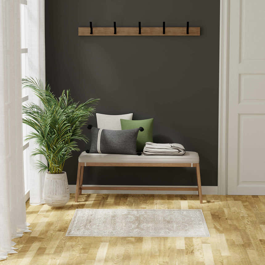 Entryway with bench, plant, and Nourison Dekor Cream Beige Vintage Indoor Area Rug on wood floor.