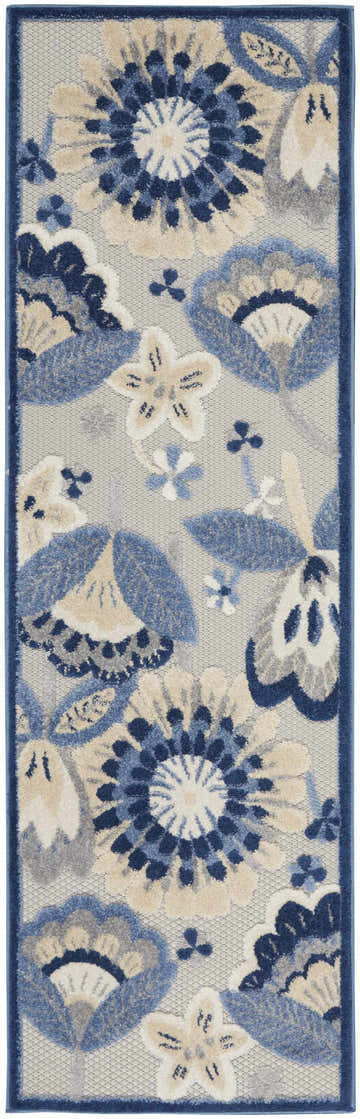 Close-up of the Nourison Aloha Blue Grey Contemporary Area Rug. Features a floral pattern in blue, gray, and beige tones.