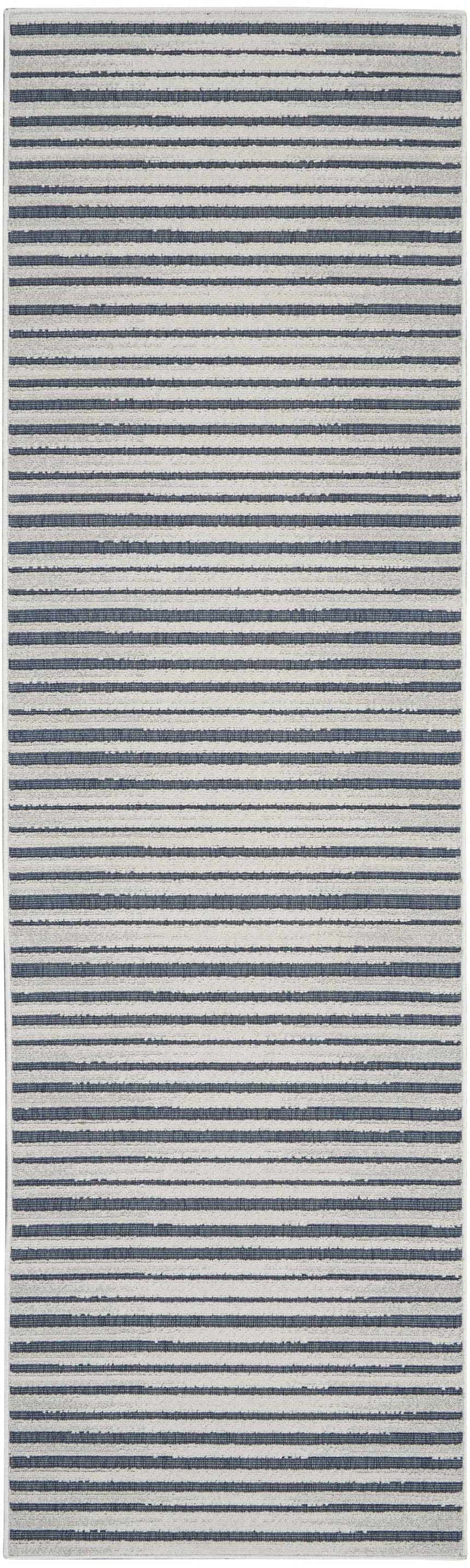 Close-up of the Nourison Key Largo Blue Contemporary Area Rug, showcasing its light blue striped pattern and soft texture.