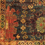 Close-up of the Nourison Jewel Denim Persian Rug, showcasing its intricate floral pattern and denim, red, and gold colors.