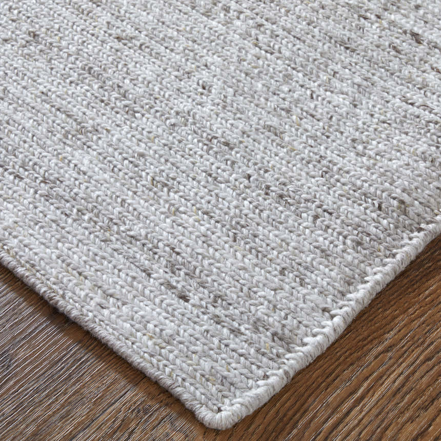 Close-up of the hand-knotted Feizy Finley Modern Solid Silver Area Rug showing texture and color. Corner