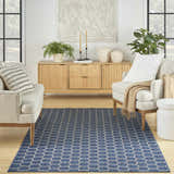 Modern living room with a light wood console and the blue Nourison Twist Reversible Area Rug.