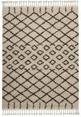 Close-up of Nourison Moroccan Shag Cream Tribal Rug featuring a diamond pattern and fringe. Soft, textured pile.