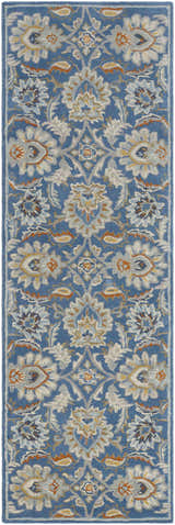 Close-up of the Fanny Area Rug. Hand-tufted wool rug in beachhouse blue with traditional beige, caramel, and gray floral pattern. Design-Runner-268