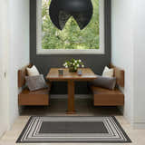 Breakfast nook with wood benches and Nourison Horizon Black Modern Area Rug.