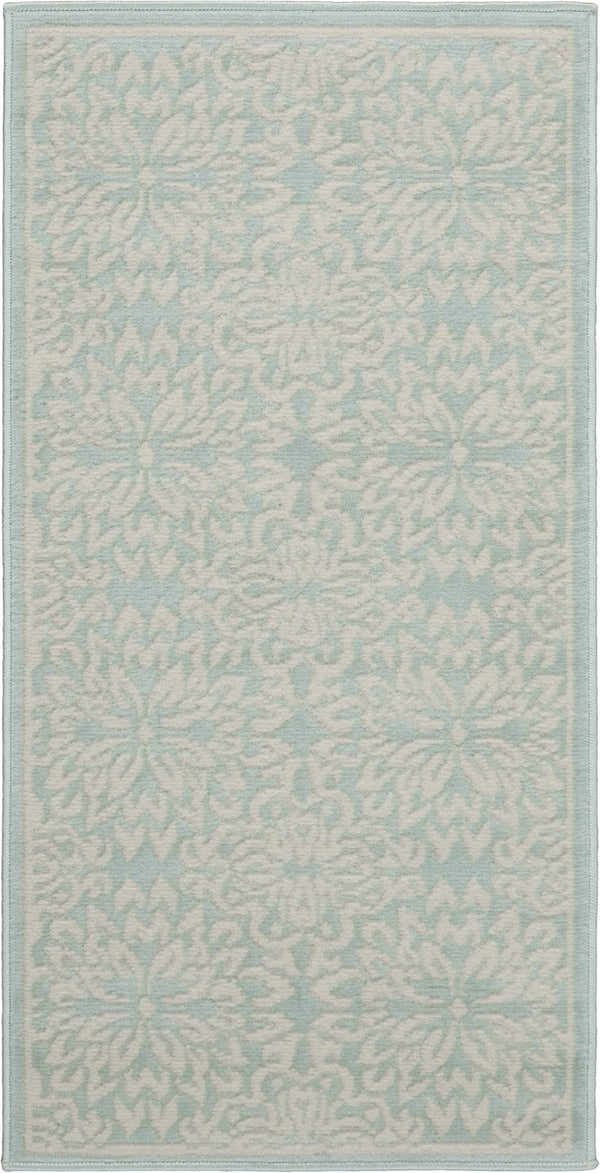 Close-up of the Nourison Jubilant Ivory Green rug, showcasing its floral pattern and soft, farmhouse style.