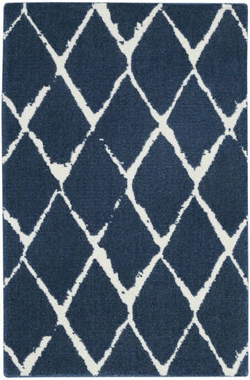 Close-up of the Nourison Twilight Navy area rug, featuring a white geometric diamond pattern on a navy blue background.