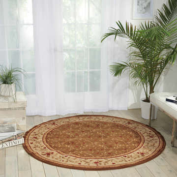 Bright sunroom with a round Nourison Ashton House Olive rug, floral pattern, and neutral furniture.