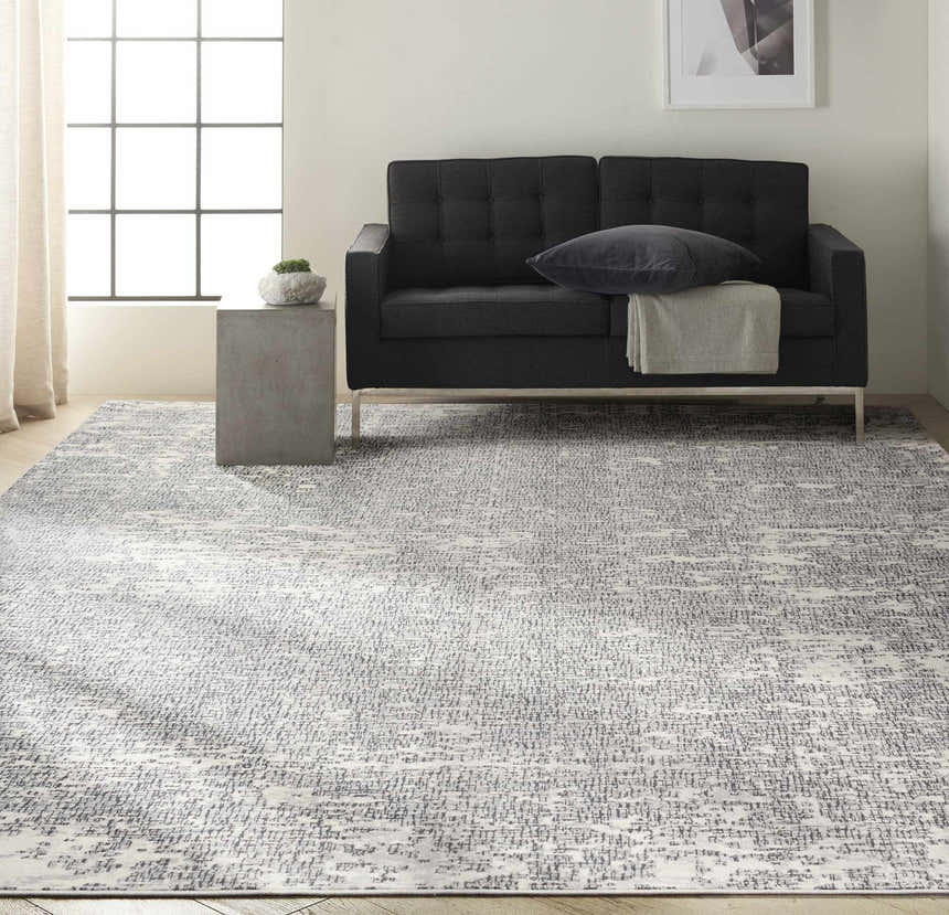 Living room with black sofa and Calvin Klein CK970 Vapor Ivory Black modern rug.