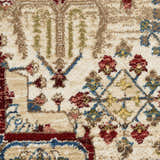 Close-up of the Nourison Karisma Ivory rug. Features chestnut, red, and blue floral and geometric farmhouse pattern.