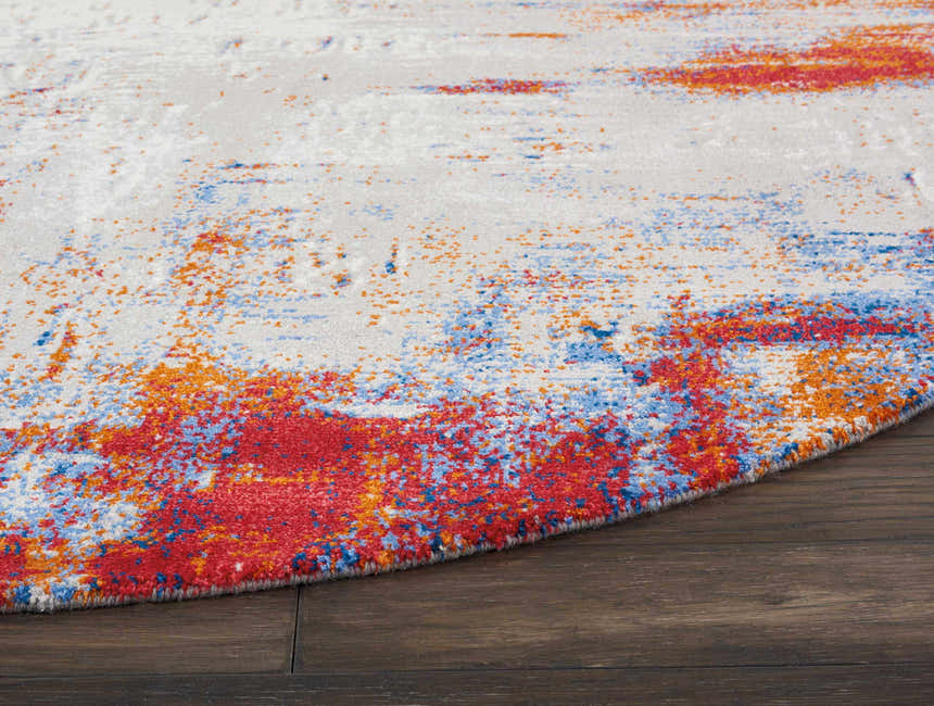 Close-up of Nourison Twilight Ivory Multicolor rug showing chestnut, blue, and orange abstract pattern and texture.