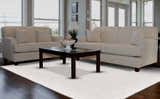 Living room scene with a Feizy Batisse Modern Solid White Area Rug, beige sofas, and a dark wood coffee table. Roomscene-Rectangle