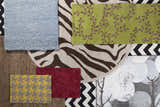 Close-up of rug samples: Greenbelt rug in ice blue, green vine, zebra, red floral, and yellow houndstooth patterns. Styleshot
