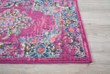 Close-up of the Nourison Passion Fuchsia rug showing its bohemian design, floral pattern, and vibrant fuchsia, blue, and pink colors.