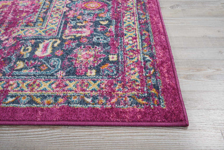 Close-up of the Nourison Passion Fuchsia Bohemian Area Rug. Features a colorful, intricate pattern and fuchsia border.