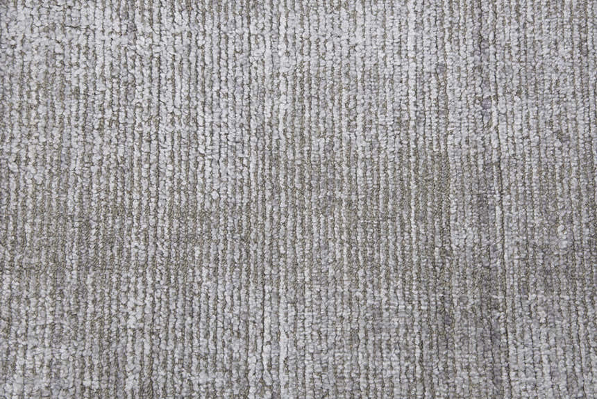 Close-up of the hand-loomed Rizzy GH718A area rug. Beige, gray, and ivory wool and Tencel fibers create a textured design. Texture