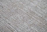 Close-up of the Rizzy GH718A area rug showing its beige, gray, and ivory tones and hand-loomed texture. Texture