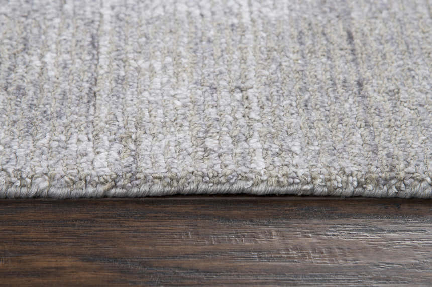 Close-up of the textured Rizzy GH718A area rug in beige, gray, and ivory on a wood floor. Pile