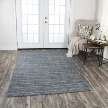 Farmhouse living room with Rizzy GH719A rug in beige, blue, and ivory. Neutral armchair and wood floors. Roomscene-Rectangle