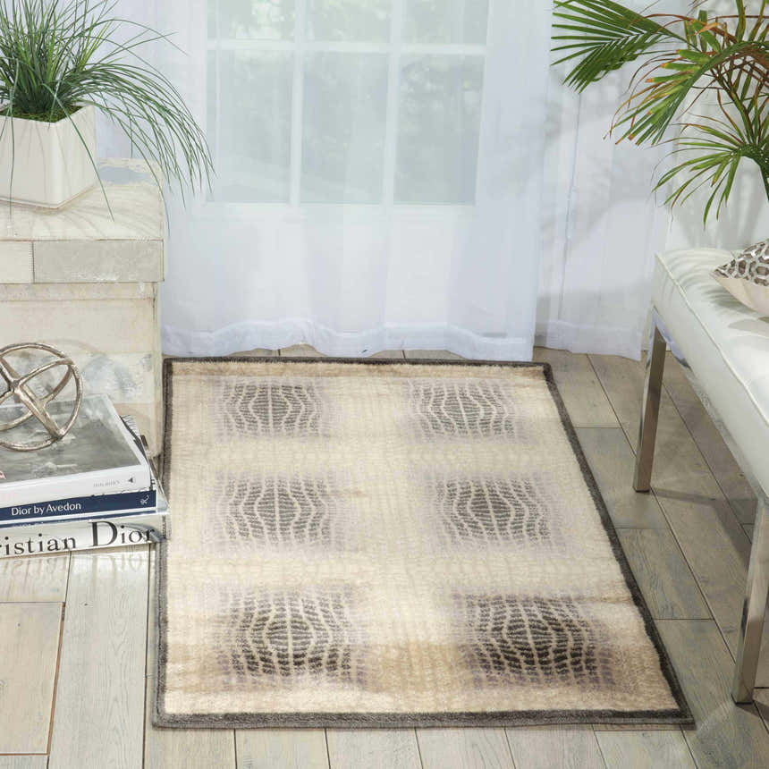 Modern living room with a Nourison Utopia Shell rug, white furniture, and plants.