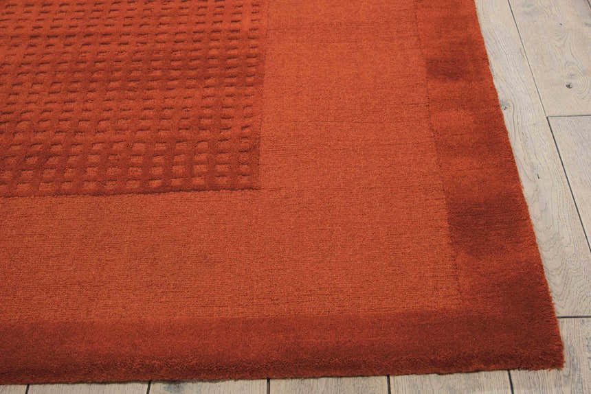 Close up of the Nourison Westport Spice Indoor Area Rug showing wool texture and subtle geometric pattern.