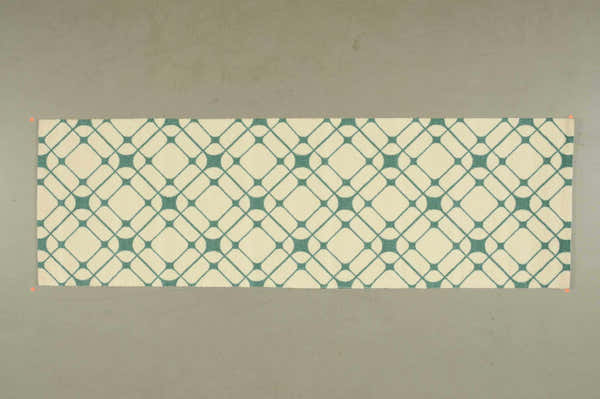 Close-up of Nourison Enhance Ivory/Turquoise runner rug, featuring a geometric diamond pattern. Chestnut accents.
