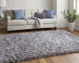 Living room with a Feizy Stoneleigh Gray/Silver rug, white sofa, blue and gray pillows, and wood floors. Roomscene-Rectangle