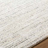 Close-up of the Sezja Beige Luxe Area Rug, showing its textured pile and subtle beige, cream, and black striations. Texture