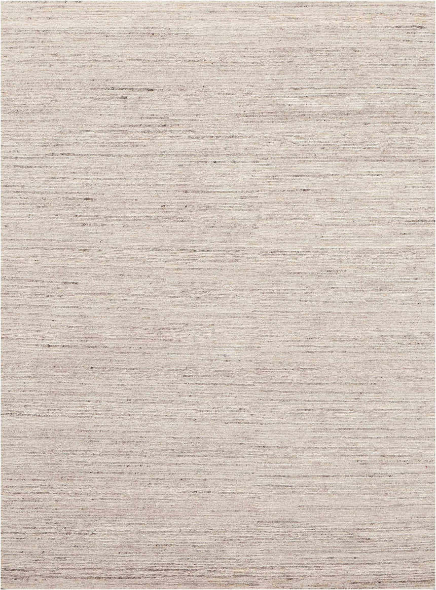 Close-up of the Nourison OCEAN Sand area rug. Handmade, mid-century modern rug in sandstone color with a subtle horizontal pattern.