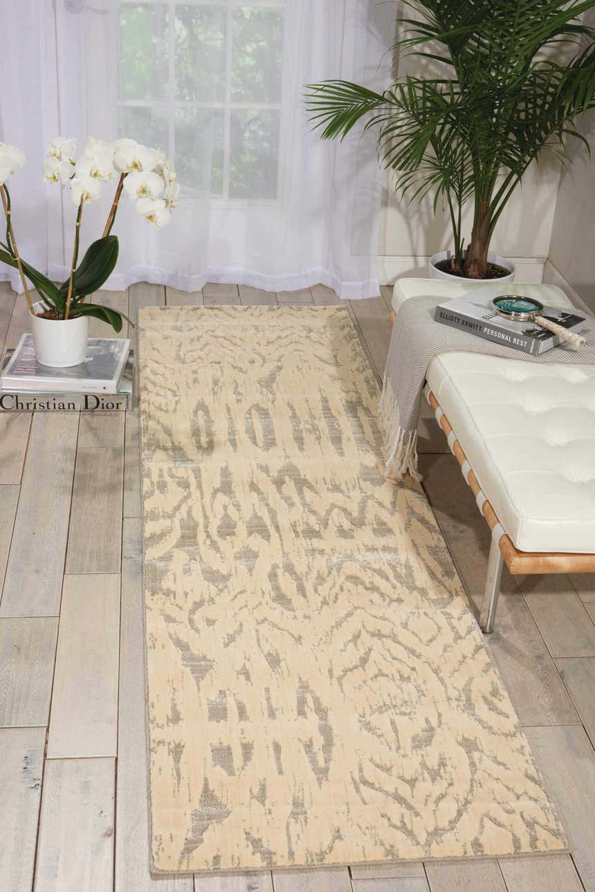 Entryway with Nourison Nepal Ivory/Grey rug, white leather bench, orchids, and palm. Vintage style.