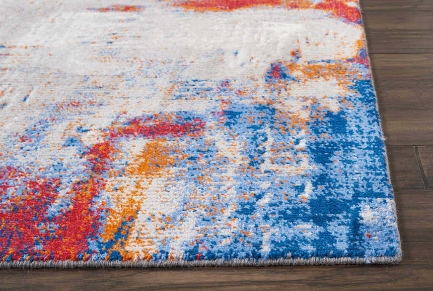 Close up of Nourison Twilight Ivory Multicolor rug showing chestnut, blue and red abstract pattern.