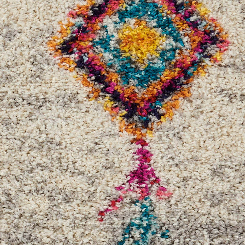 Close-up of the Nourison Nomad Cream Grey Tribal Rug, showing the cream shag texture and colorful tribal diamond pattern.