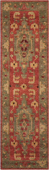 Close-up of the Nourison Tahoe Rust rug. Features a traditional design with rust, green, and gold tones. Handmade wool texture.