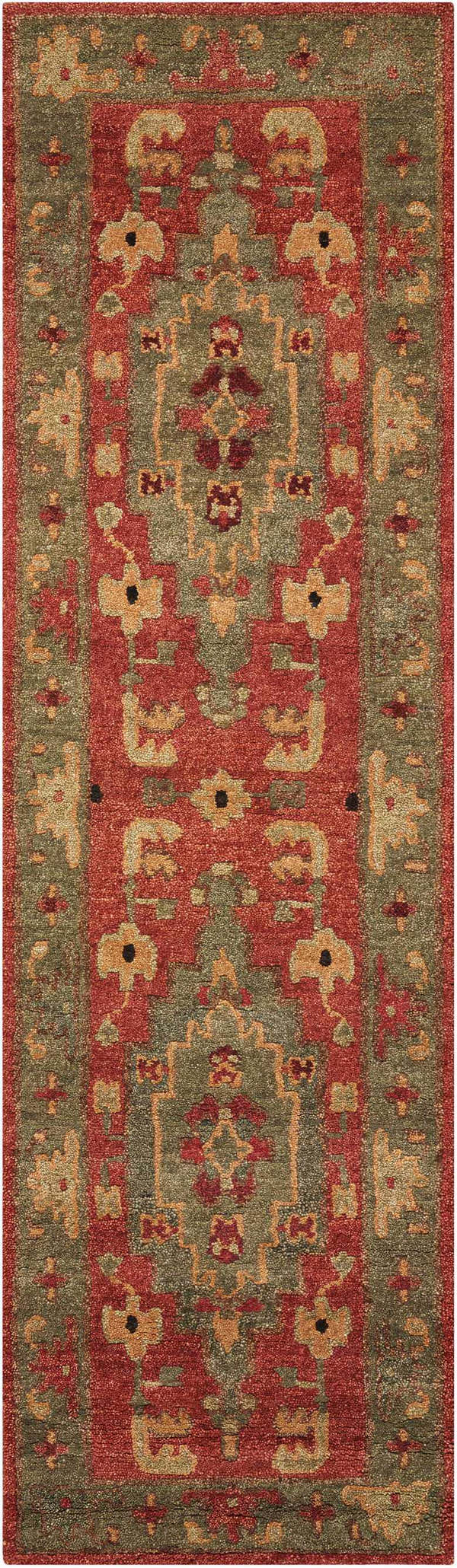 Close-up of the Nourison Tahoe Rust rug. Features a traditional design with rust, green, and gold tones. Handmade wool texture.