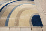 Close-up of Nourison Somerset Ivory Blue rug showing its modern curved pattern and soft texture on a wood floor.