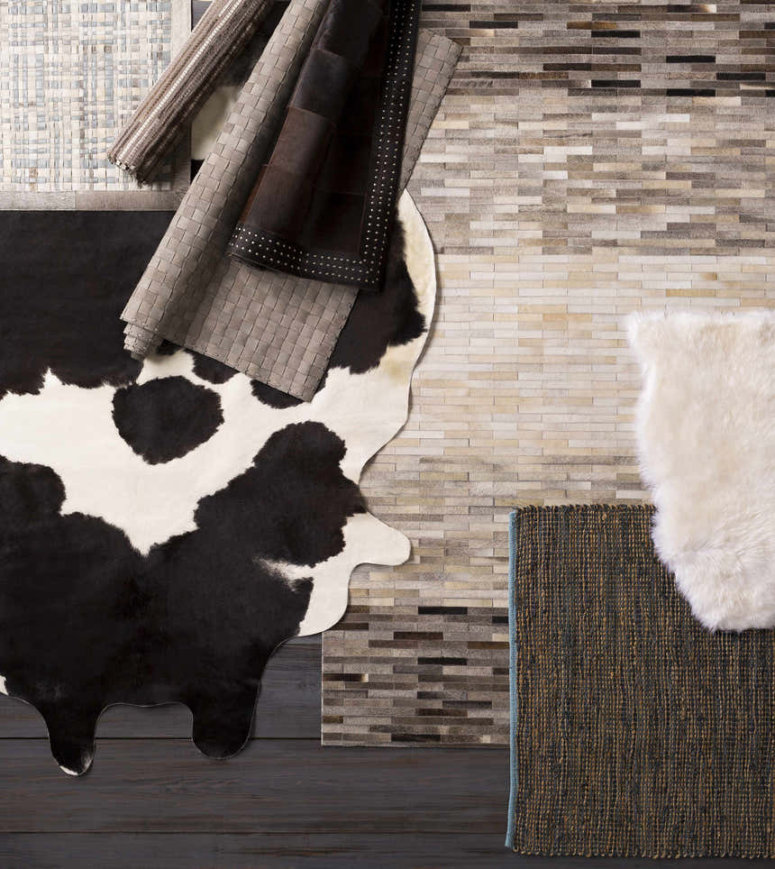 Sunburst Area Rug and other leather rugs in gray, brown, black, and white, with woven and animal print textures. Styleshot