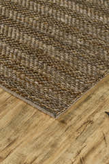 Close-up of the hand-woven Feizy Kaelani area rug. Brown and gray geometric pattern, jute and cotton texture. Corner