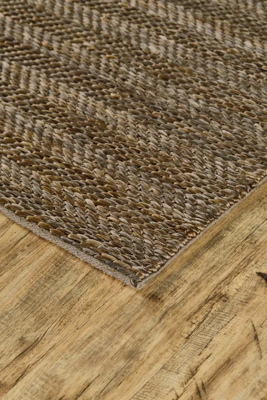 Close-up of the hand-woven Feizy Kaelani area rug. Brown and gray geometric pattern, jute and cotton texture. Corner