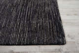 Close-up of the handmade Nourison OCEAN Onyx rug, featuring a black and gray striped pattern and textured design.