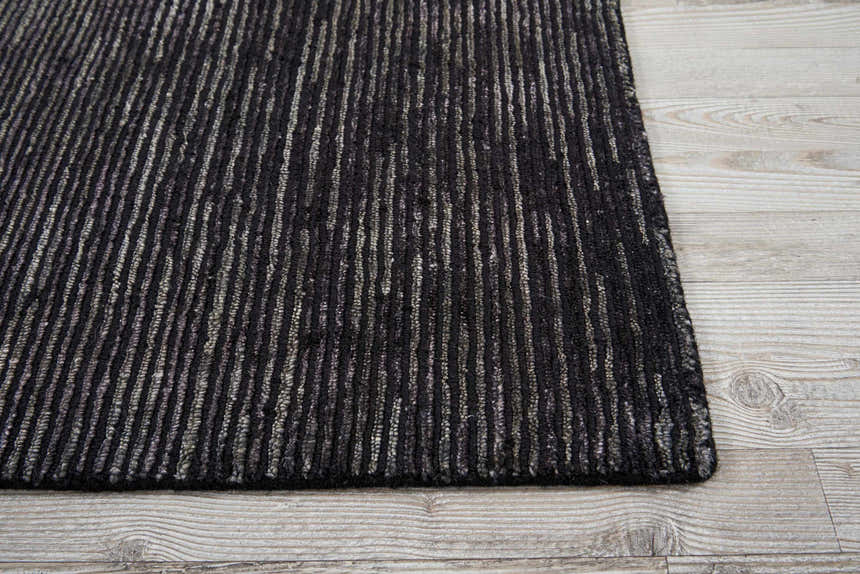 Close-up of the handmade Nourison OCEAN Onyx rug, featuring a black and gray striped pattern and textured design.
