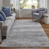 Living room scene with a Feizy Cadiz Taupe/Gray/Silver Area Rug, sofa with blue pillows, and gray chair. Roomscene-Rectangle