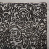 Close up of the hand knotted Rizzy HTN720 area rug. Gray and ivory wool with a traditional farmhouse pattern and textured pile. Corner