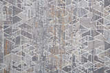 Close-up of the Feizy Francisco rug. Abstract geometric pattern in gray, blue, and orange hues. Soft, textured surface. Texture