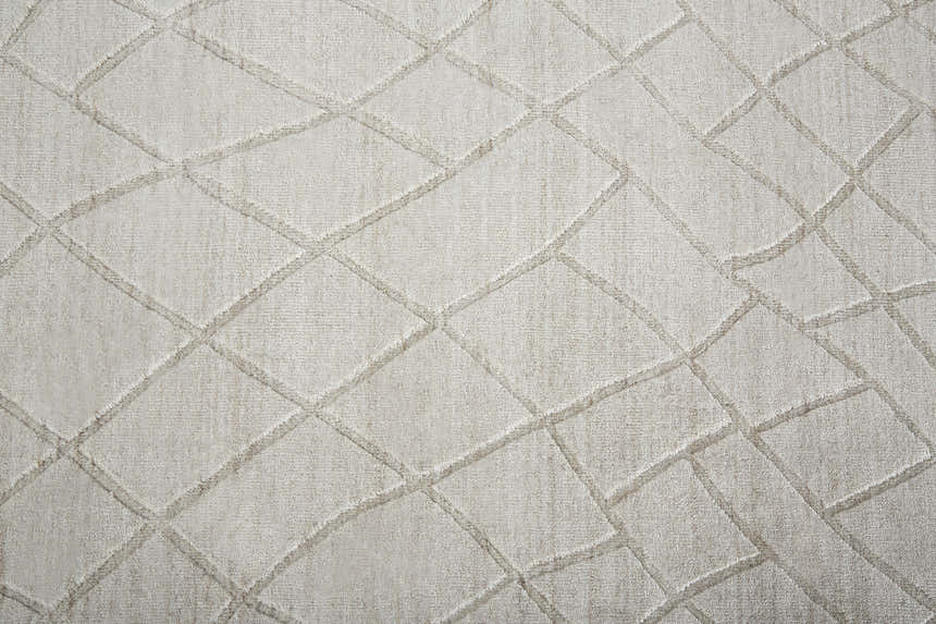 Close-up of the Feizy Redford rug in ivory and gray, featuring a textured diamond pattern and hand-woven construction. Texture
