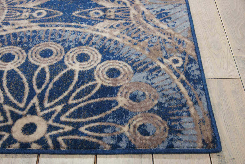 Close-up of Nourison Somerset Denim rug showing blue, gray, and cream mid-century modern floral pattern and texture.